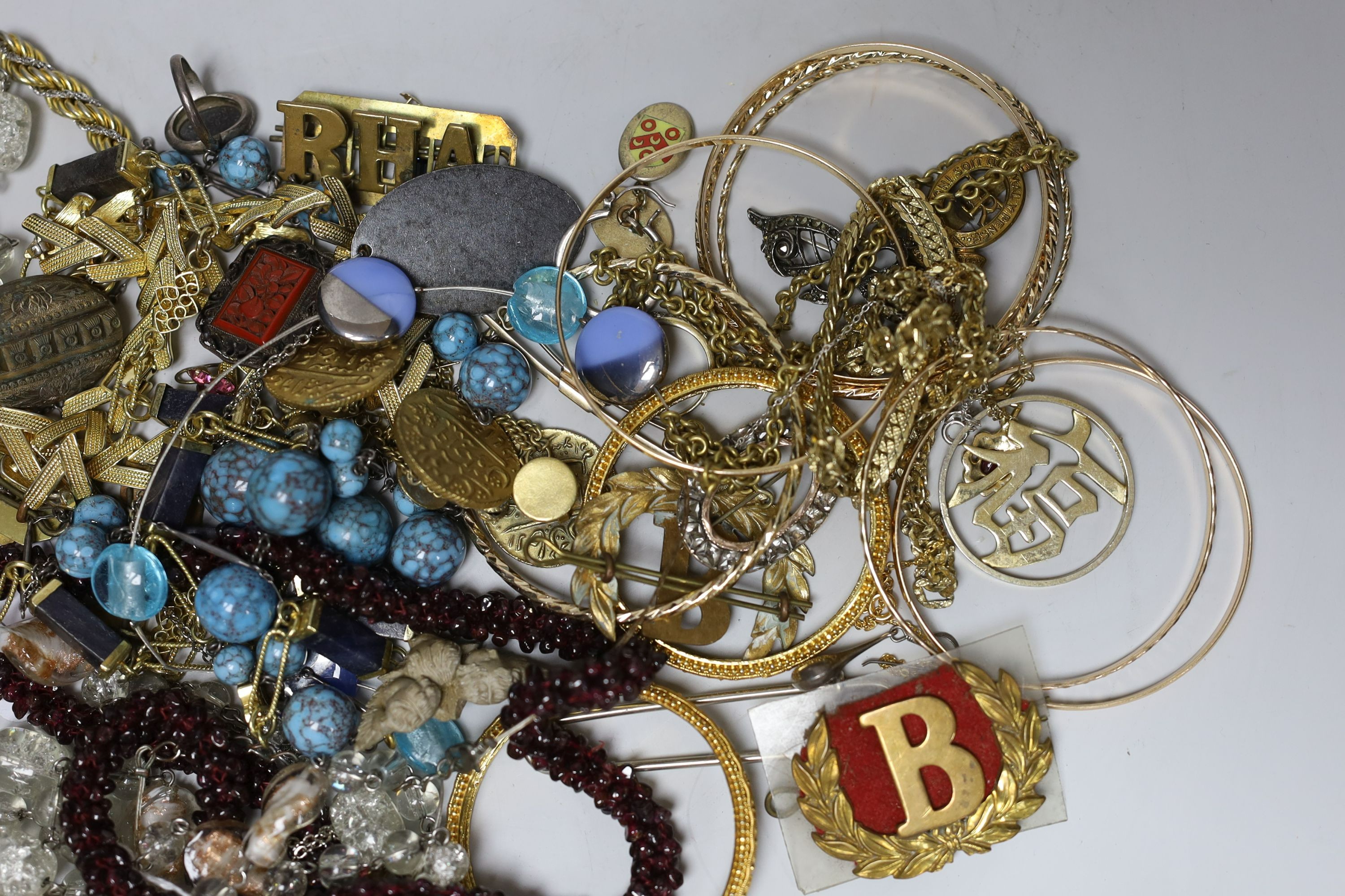 A quantity of assorted costume jewellery and other items including silver and enamel plaque and a garnet bead necklace.